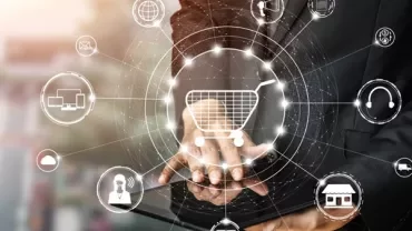 Person using a tablet with digital shopping icons overlay.