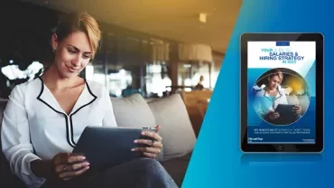 Person reading a tablet in a modern office setting.