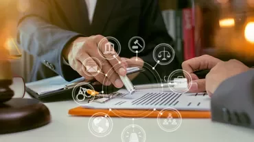 Close-up of hands signing a document with digital legal icons overlay.