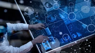 Person interacting with a large digital display showing data and graphics.