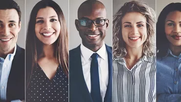 Five smiling people in business attire.